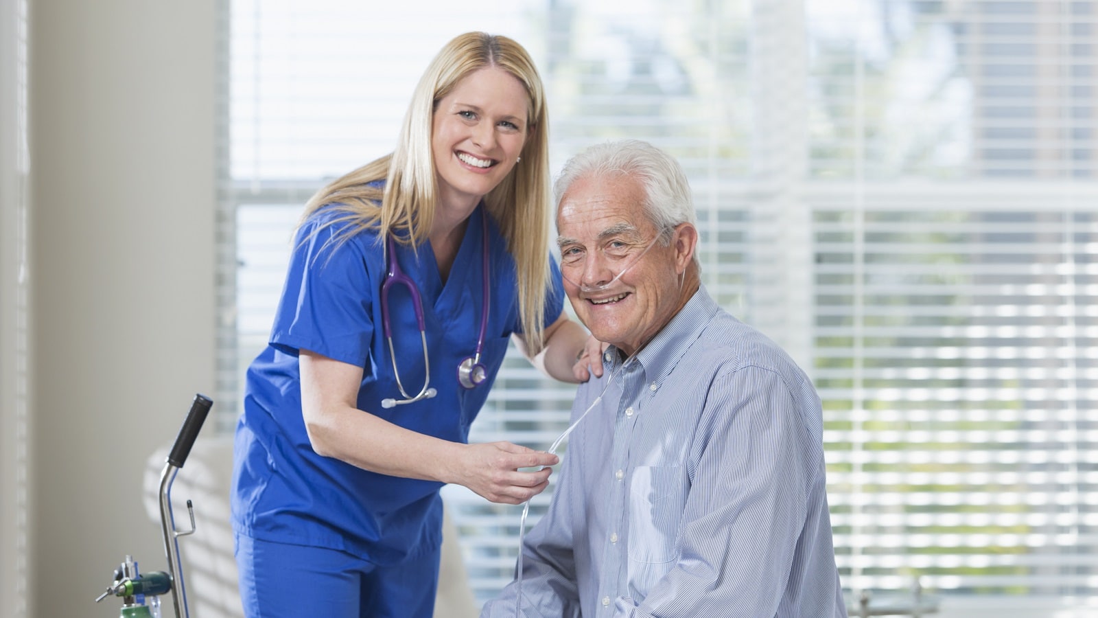 Photo: Healthcare worker helping elderly man with oxygen