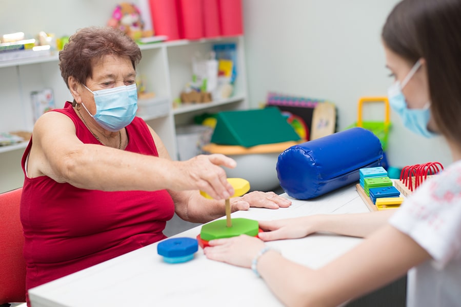 Photo: Healthcare worker assisting patient with physical therapy