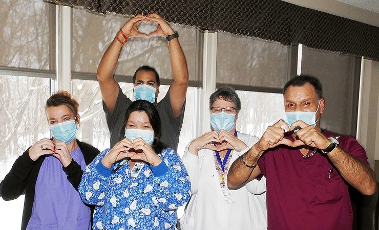 Photo: St. Camillus employees positioning hands into heart shapes