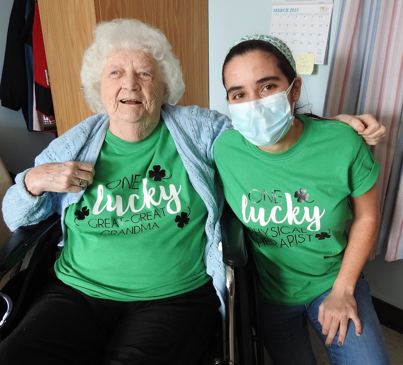 Photo: St. Camillus employee with resident wearing festive green shirts